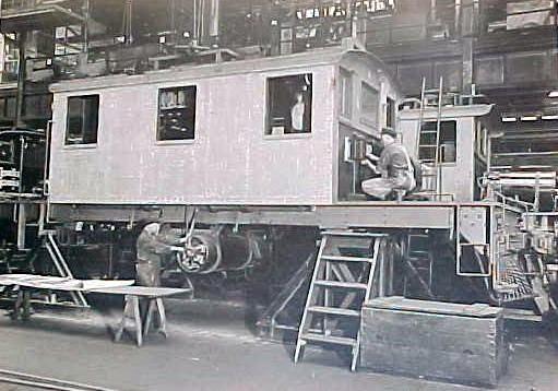 Workers constructing railroad cars.