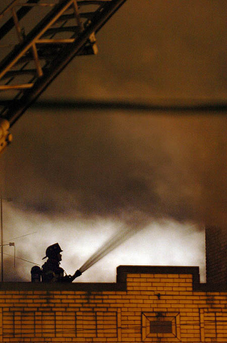 2005 - A firefighter hoses down a three-alarm
blaze in Brookline that sent one Pittsburgh
firefighter to the Hospital. Fire broke
through the roof of the three-story building
at 704 Brookline Blvd., just across the street
from Pittsburgh Engine House 26 around 4:30pm.