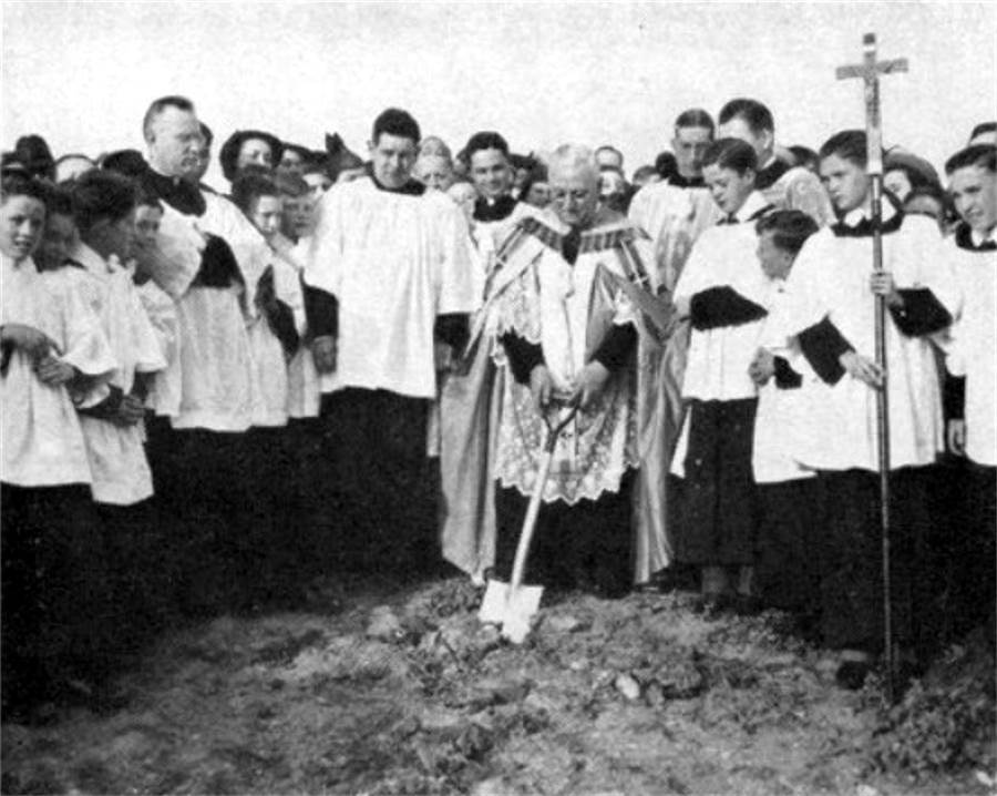 Father Quinn breaks ground on the
new church on April 25, 1938