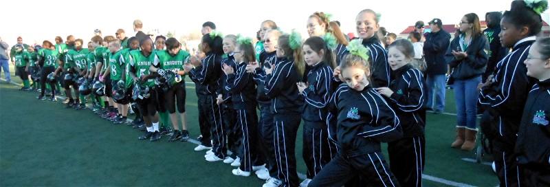 The Players and Cheerleaders await the presentation
of the Super Bowl trophy to Head Coach Don Helman