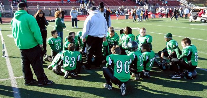 The Knights gather at midfield after the game.
There's a lot of sad faces in the crowd. In a day
or two these kids should realize that they actually
had a great season and have much to be proud of.