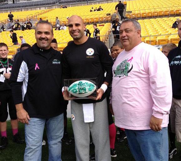 Brian and Joe Nicholas present a signed football
to Pittsburgh Steeler Bruce Gradkowski on October 20, 2013.