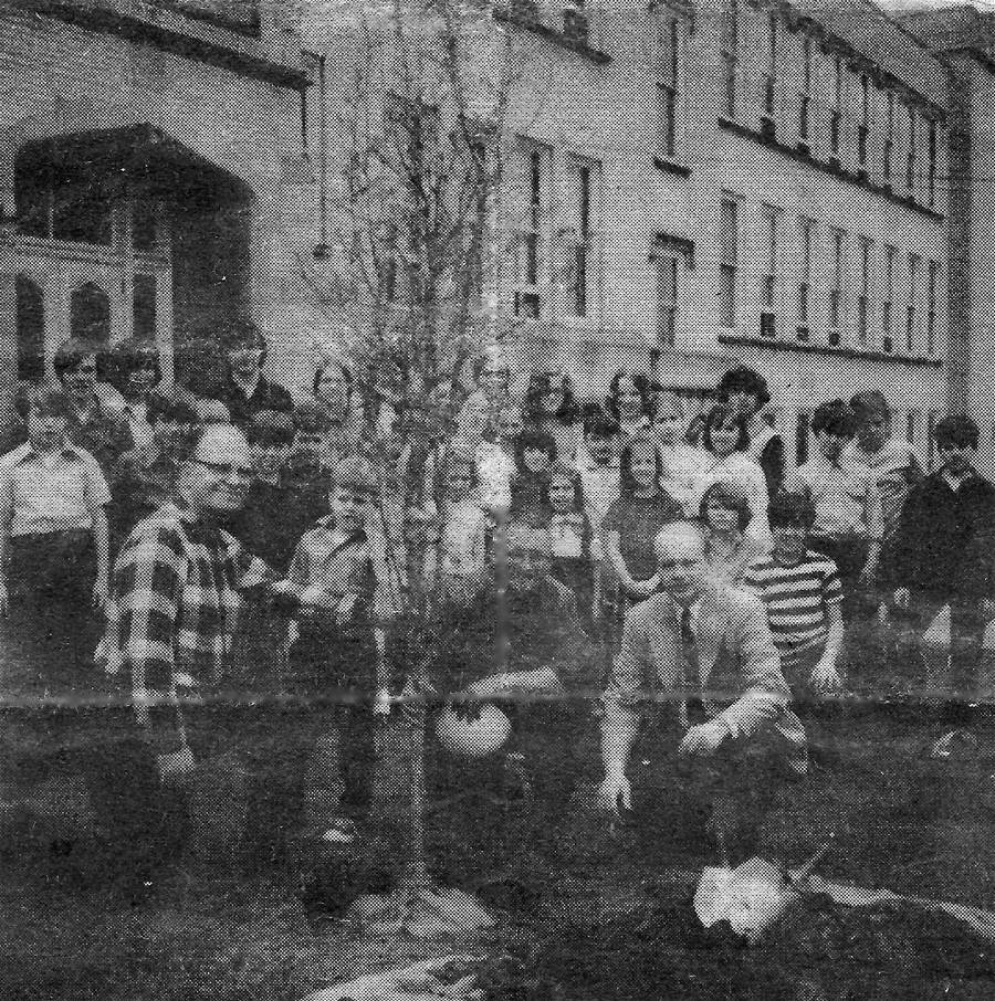 Picture of students gathered around
newly planted tree - May 1, 1972.
